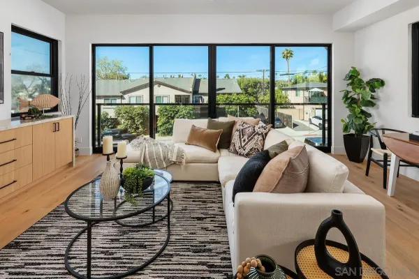 a living room with furniture and a floor to ceiling window