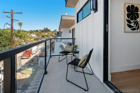 a view of a balcony with furniture and a potted plant
