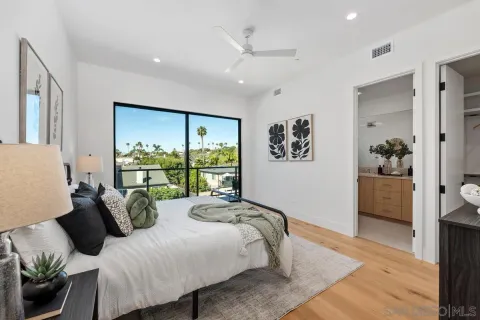 a bedroom with furniture and a large window