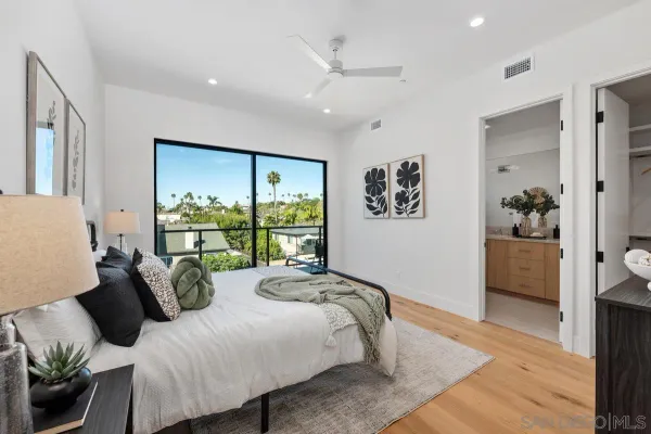 a bedroom with furniture and a large window