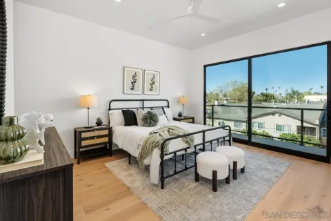 a bedroom with a bed and large window