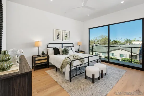 a bedroom with a bed and large window