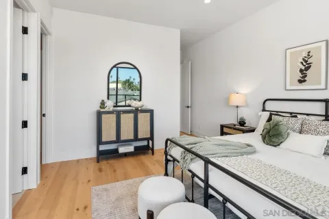 a bedroom with a bed and wooden floor