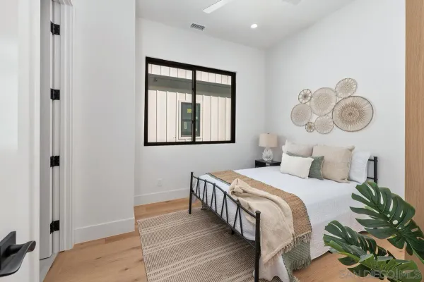 a bedroom with a bed and a window