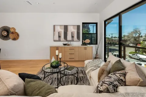 a living room with furniture and floor to ceiling window