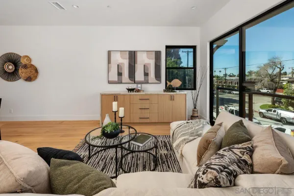 a living room with furniture and floor to ceiling window