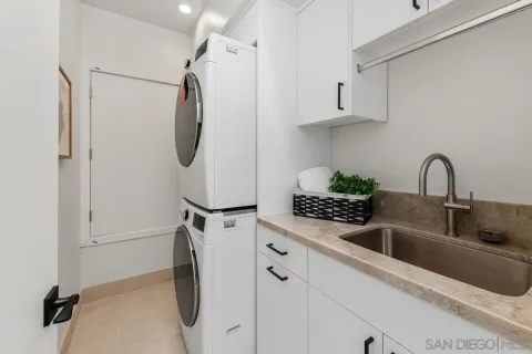 a bathroom with a granite countertop sink a toilet and shower
