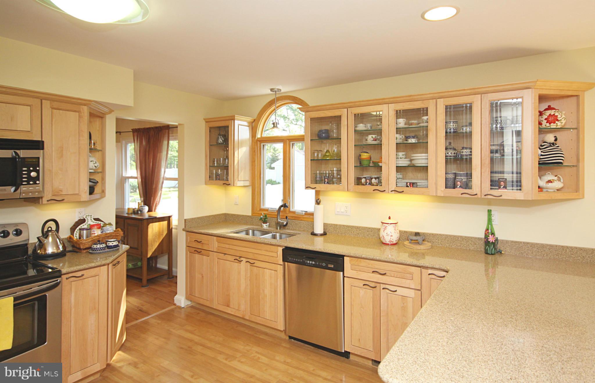 7707 Mahogany Road Severn, MD 21144 - Photo 7 of 30 a kitchen with stainless steel appliances granite countertop a sink stove and cabinets