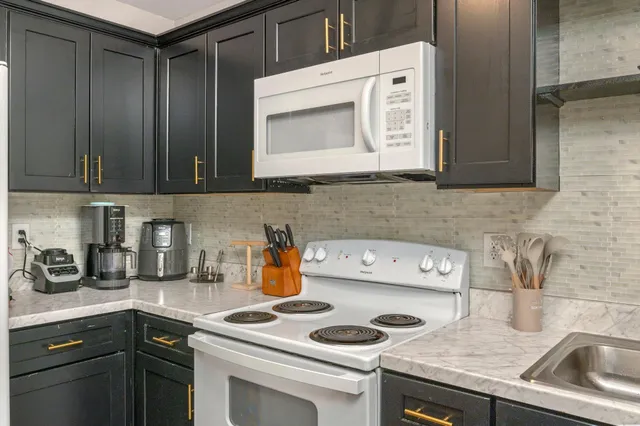 a kitchen with a sink stove and cabinets