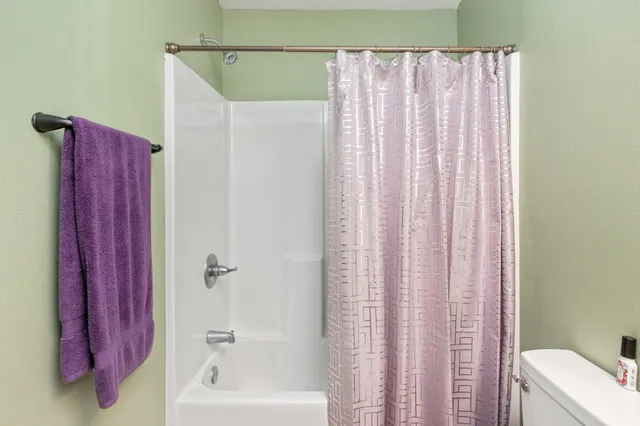 a bathroom with a shower curtain and a curtain