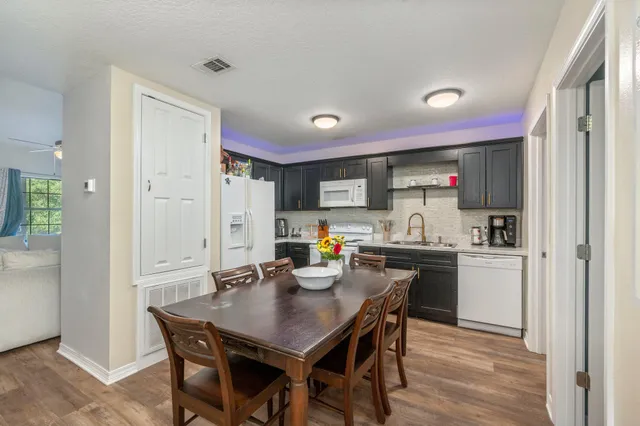 a kitchen that has a table and chairs in it