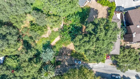 an aerial view of a house with yard