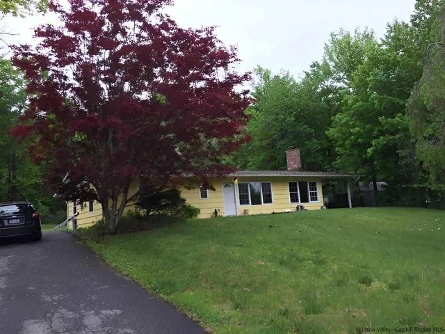 a view of a house with a yard