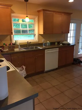 a kitchen with a sink window and cabinets