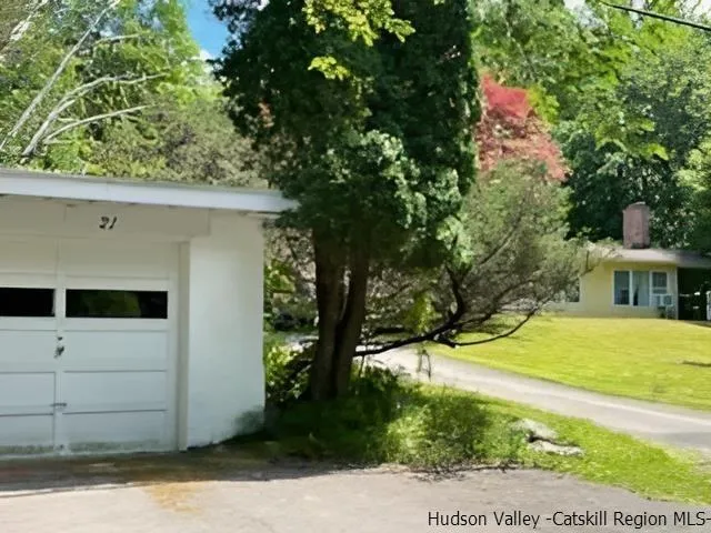 a view of a house with a backyard