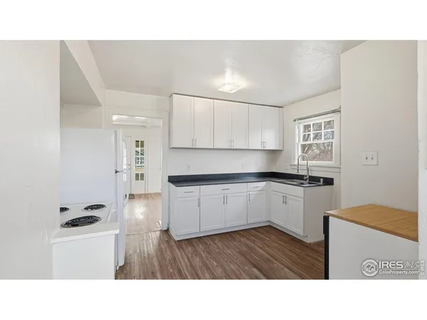 a kitchen with sink and cabinets