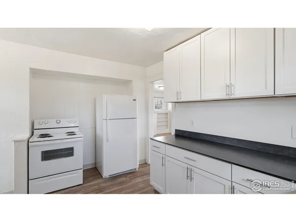 a kitchen with a white cabinets and white appliances
