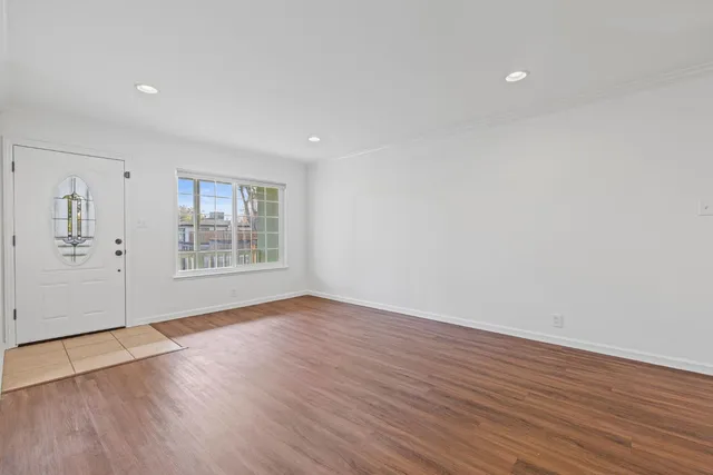 wooden floor in an empty room with a window