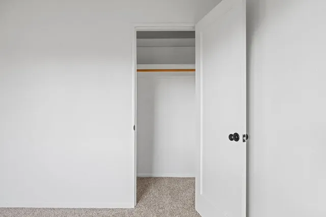 an aerial view of residential house with parking and trees