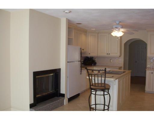 61 Bullivant Farm Road Marion, MA 02738 - Photo 3 of 14 a kitchen with stainless steel appliances granite countertop a stove a refrigerator a sink a dining table and chairs