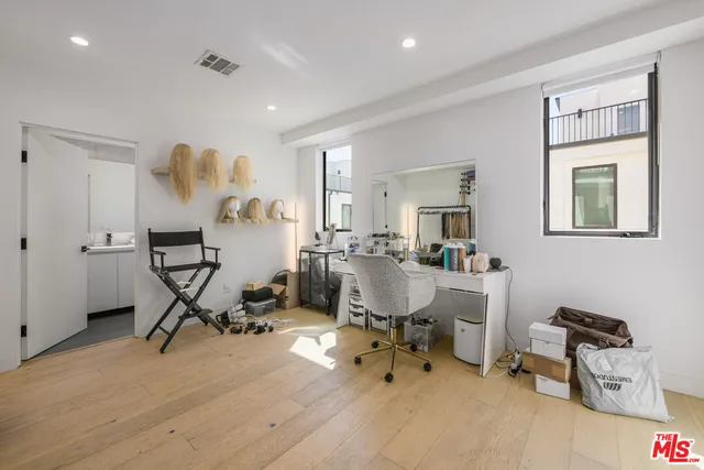 a living room with furniture a flat screen tv and a table