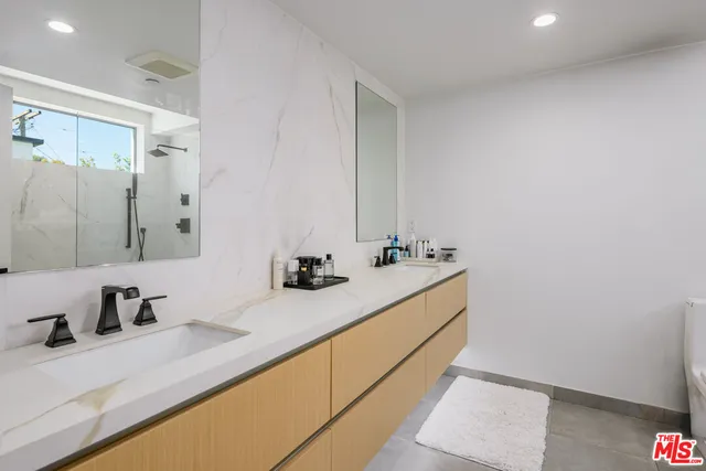 a white toilet sitting next to a bathroom shower