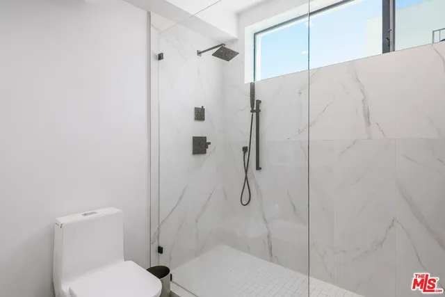 a bedroom with a large bed and a couch