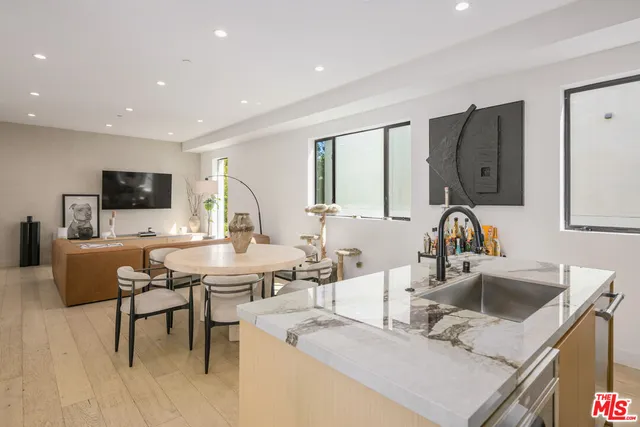 a kitchen with stainless steel appliances granite countertop a refrigerator a sink and a stove