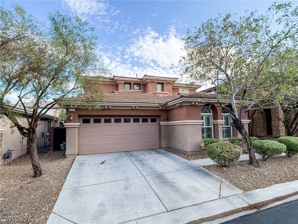 8683 Moreno Mountain Avenue Las Vegas, NV 89178 - Photo 1 of 26 A well-maintained desert landscape frames this two-story residence with an attached garage.