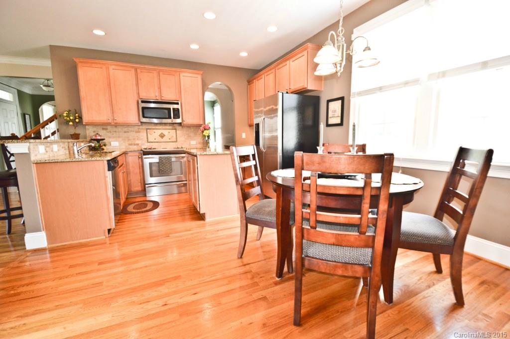 704 Shady Grove Crossing, Unit 496 Fort Mill, SC 29708 - Photo 8 of 20 a dining hall with stainless steel appliances a dining table and chairs