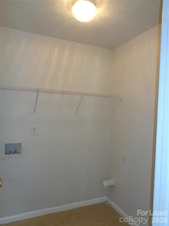 a bathroom with a white toilet and vanity