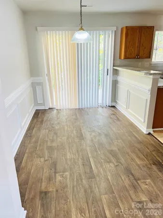 a view of a kitchen with wooden floor and staircase