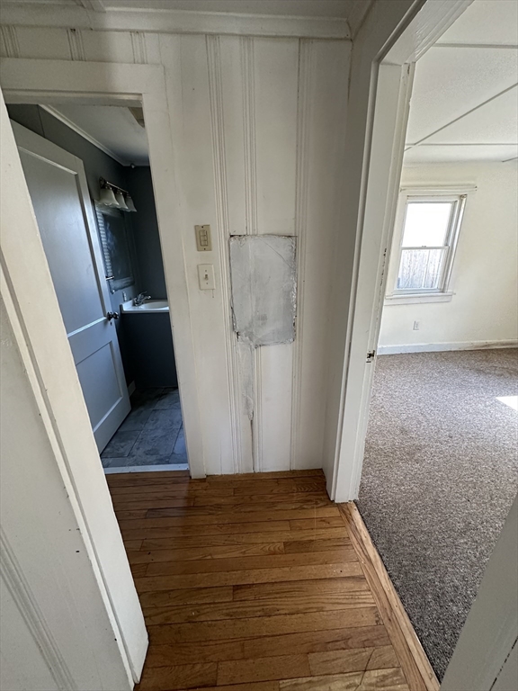 163 Ninigret Avenue Mashpee, MA 02649 - Photo 6 of 17 a view of an empty room with wooden floor and stairs