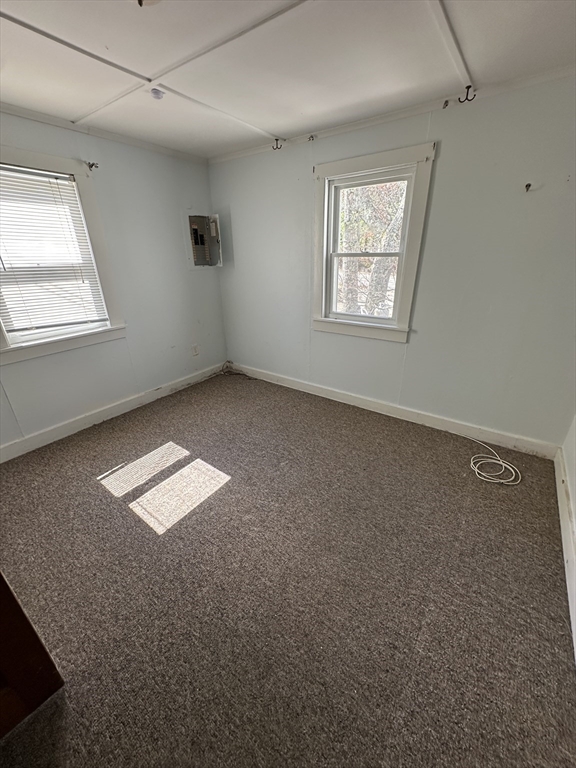 163 Ninigret Avenue Mashpee, MA 02649 - Photo 7 of 17 an empty room with windows