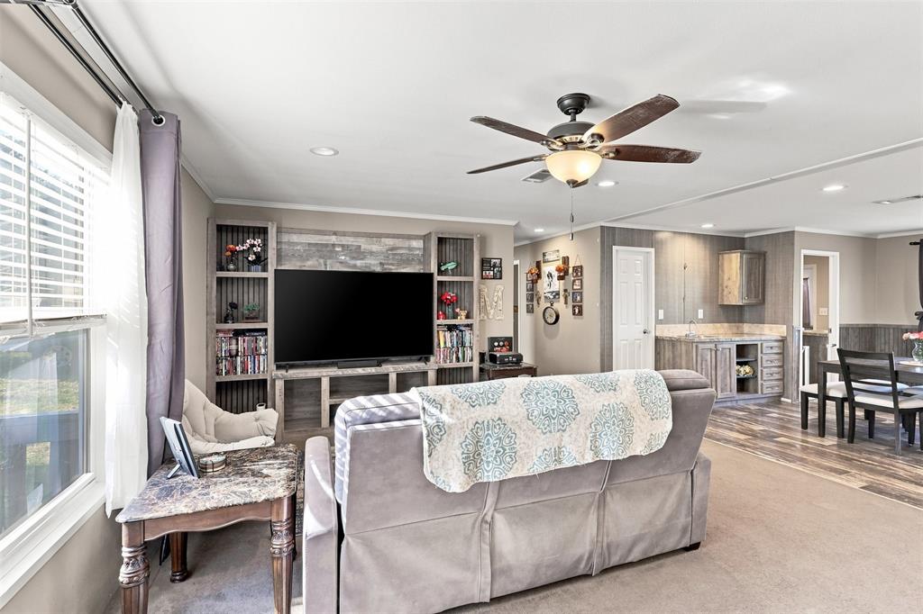 5519 Upper Denton Road Weatherford, TX 76085 - Photo 11 of 38 Built-in entertainment center with open shelving, ceiling fan with light fixture, recessed lighting, and wood-finish flooring