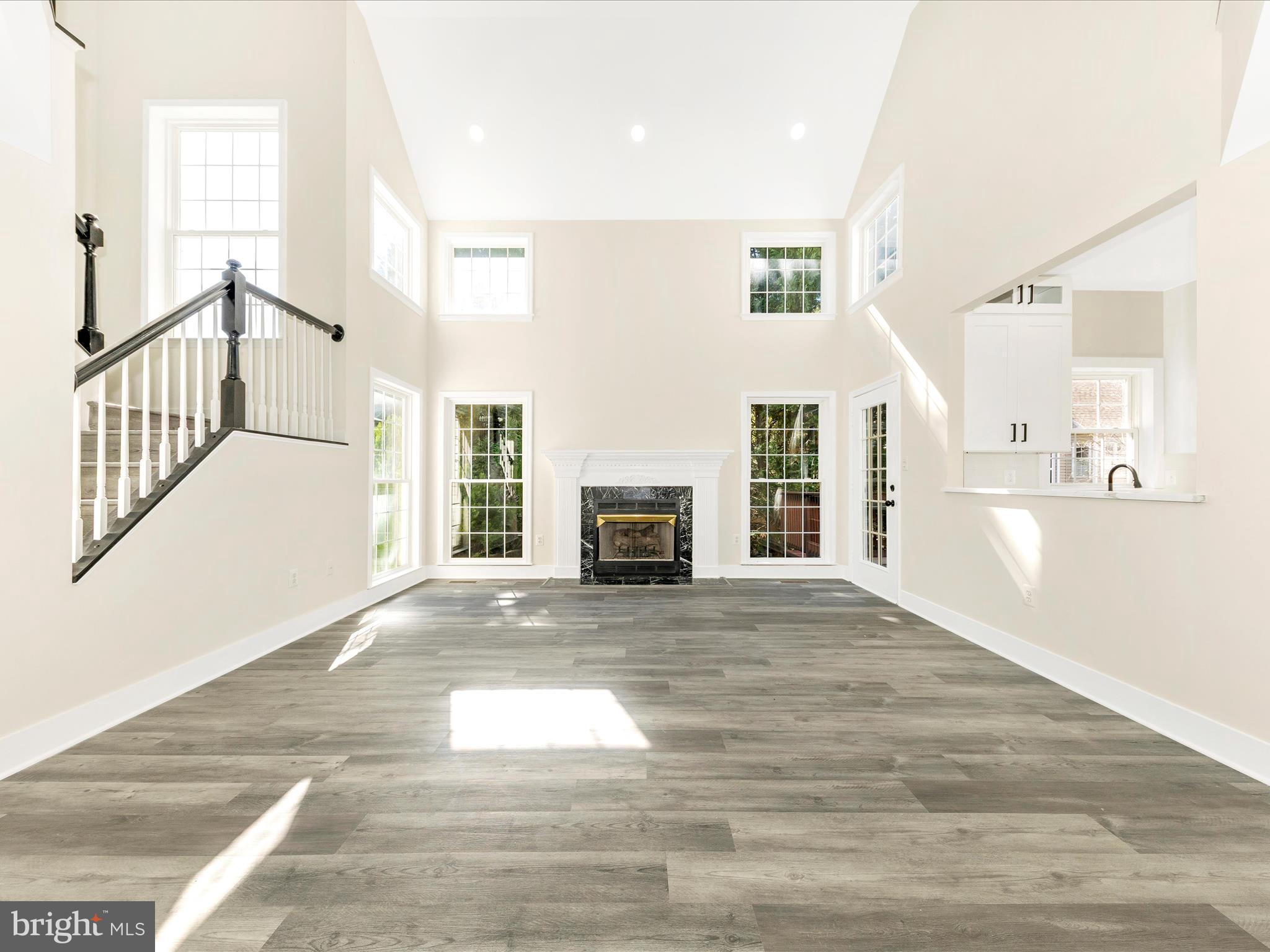 2621 Bear Den Road Frederick, MD 21701 - Photo 17 of 77 a view of an empty room with wooden floor and a window