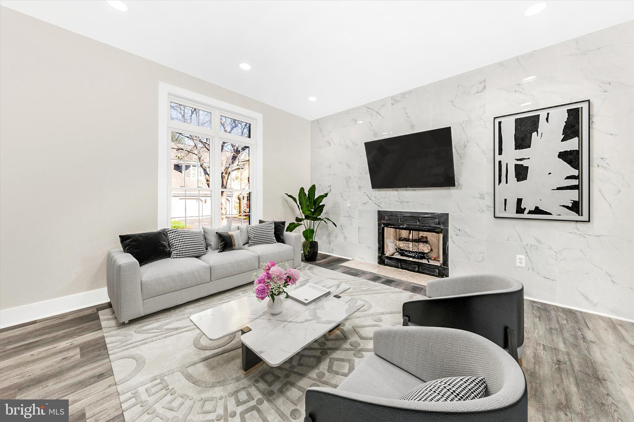 2621 Bear Den Road Frederick, MD 21701 - Photo 2 of 77 a living room with furniture a fireplace and a flat screen tv