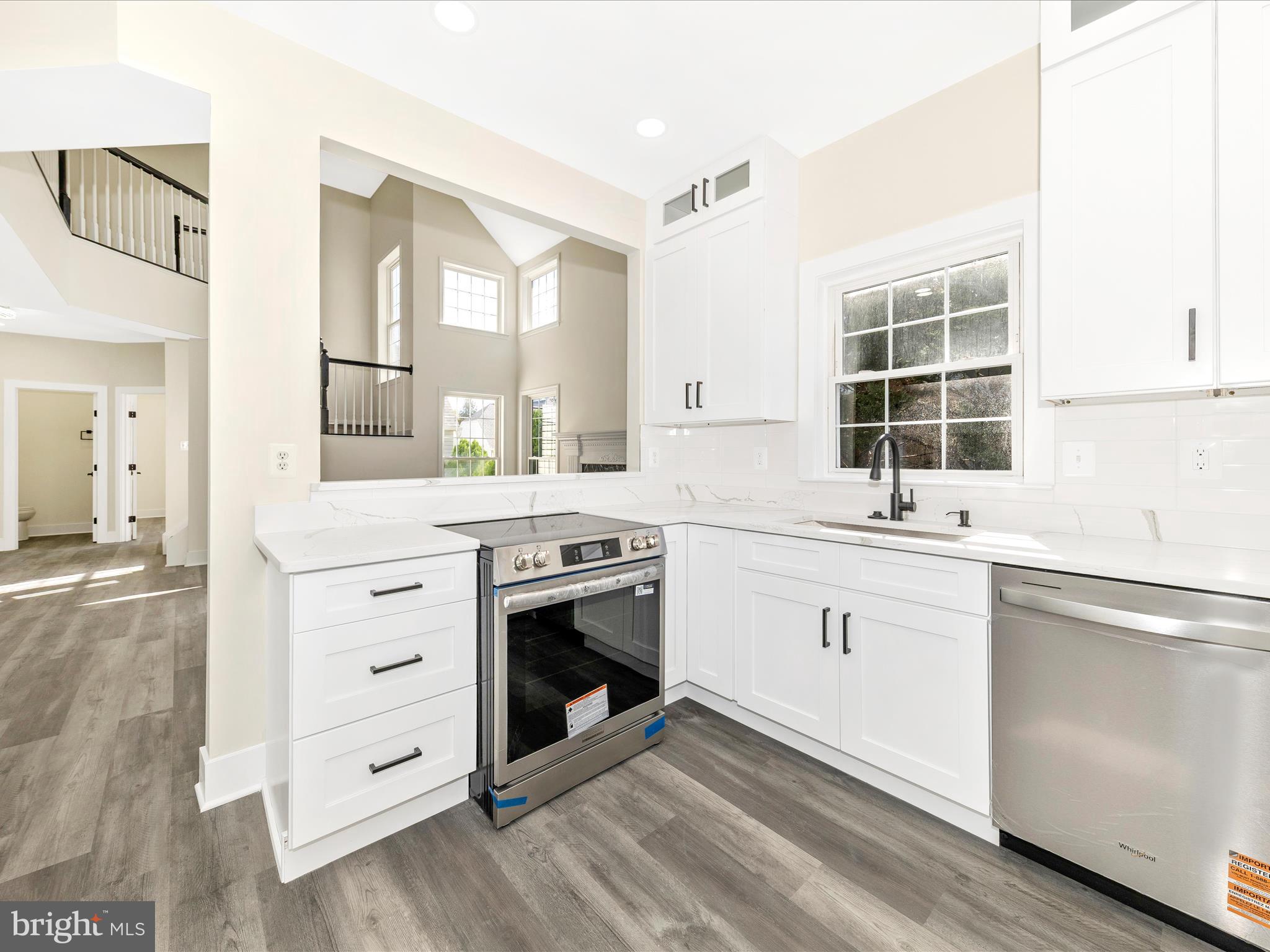 2621 Bear Den Road Frederick, MD 21701 - Photo 21 of 77 a kitchen with granite countertop a stove and a sink