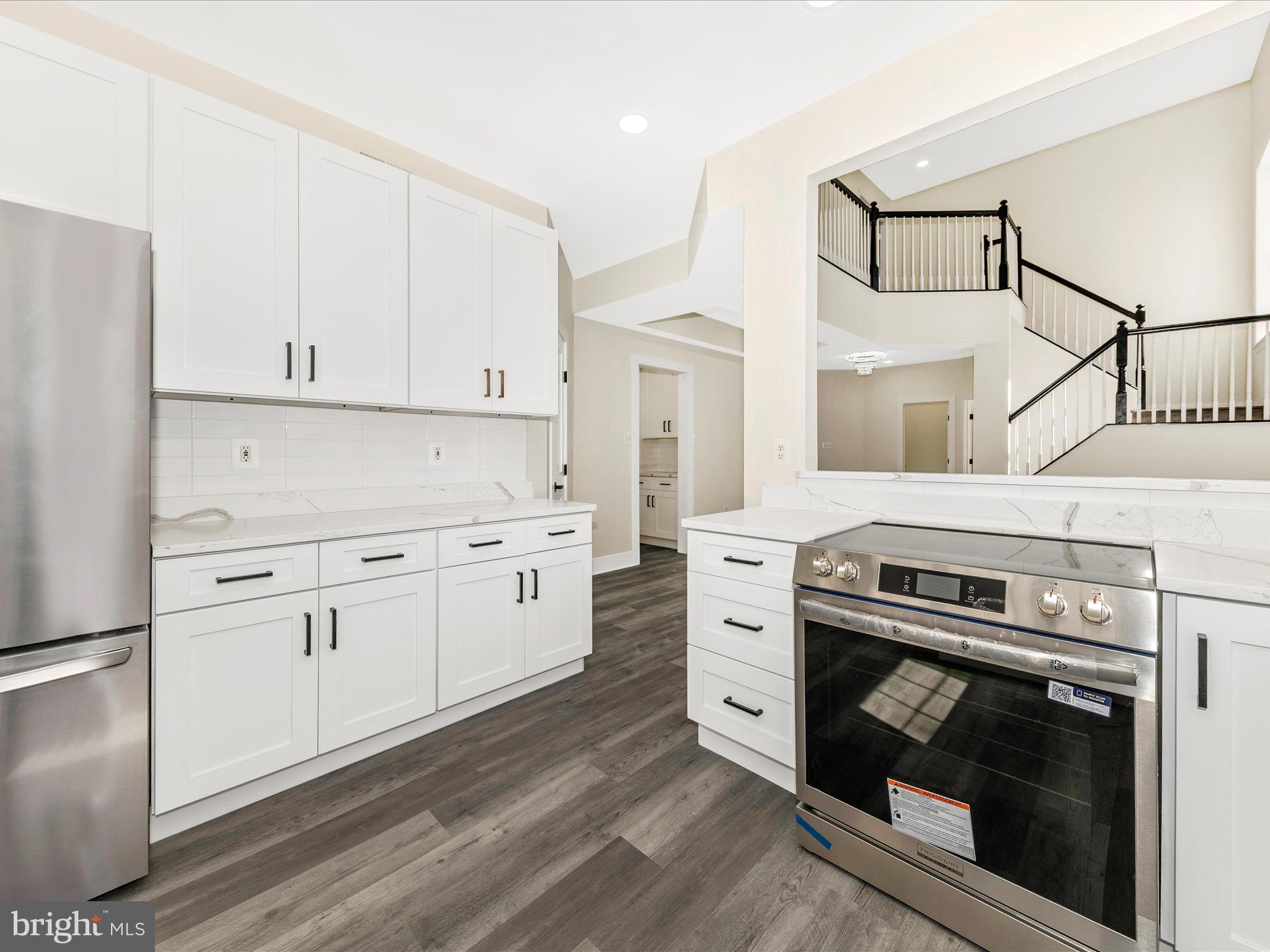 2621 Bear Den Road Frederick, MD 21701 - Photo 23 of 77 a kitchen with cabinets stainless steel appliances and wooden floor