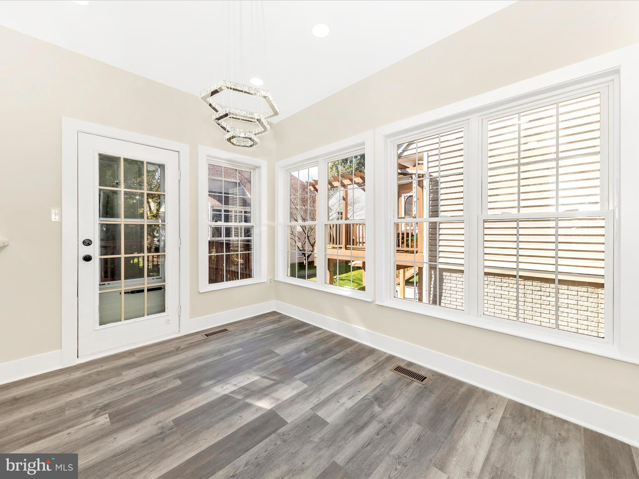 2621 Bear Den Road Frederick, MD 21701 - Photo 24 of 77 a view of an empty room with a window and wooden floor