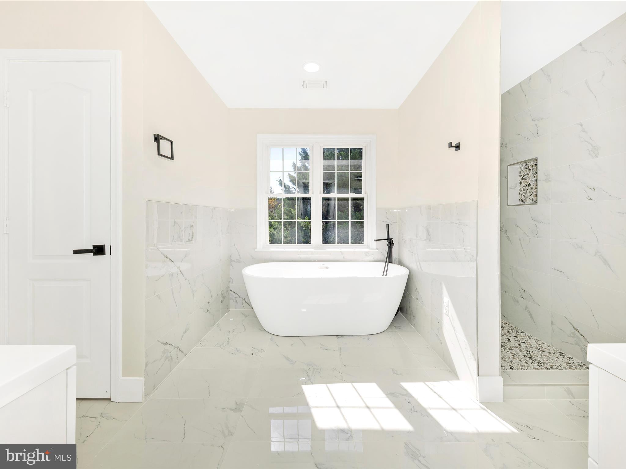 2621 Bear Den Road Frederick, MD 21701 - Photo 34 of 77 a white bath tub sitting next to a white cabinet