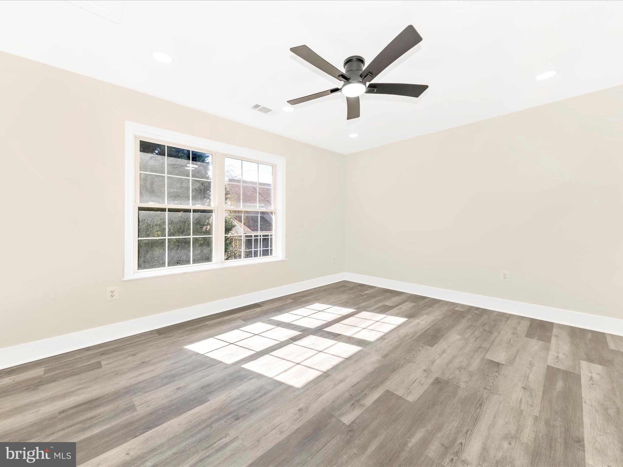 2621 Bear Den Road Frederick, MD 21701 - Photo 37 of 77 an empty room with wooden floor and windows