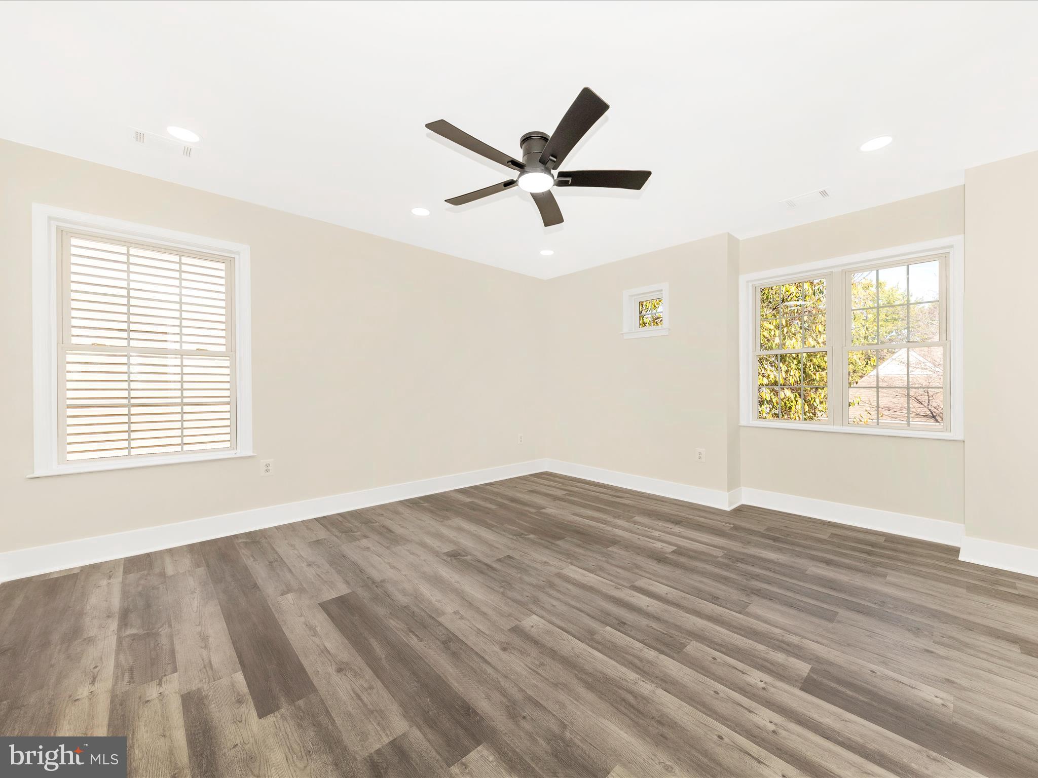 2621 Bear Den Road Frederick, MD 21701 - Photo 38 of 77 a view of an empty room with wooden floor and a window
