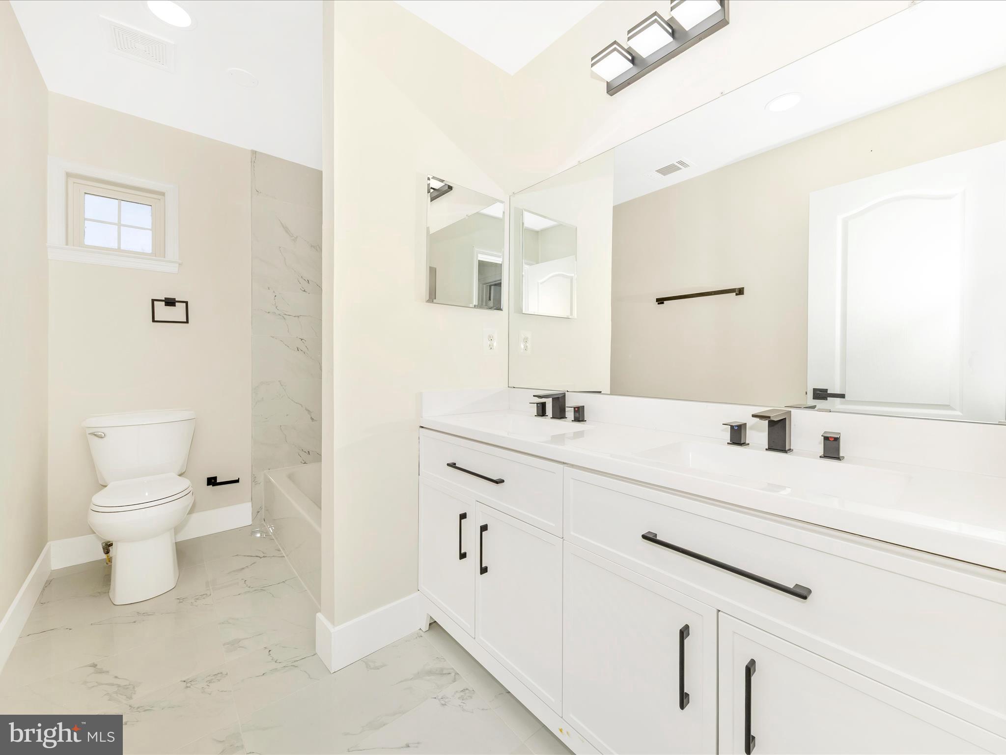 2621 Bear Den Road Frederick, MD 21701 - Photo 39 of 77 a bathroom with a sink a toilet and a mirror