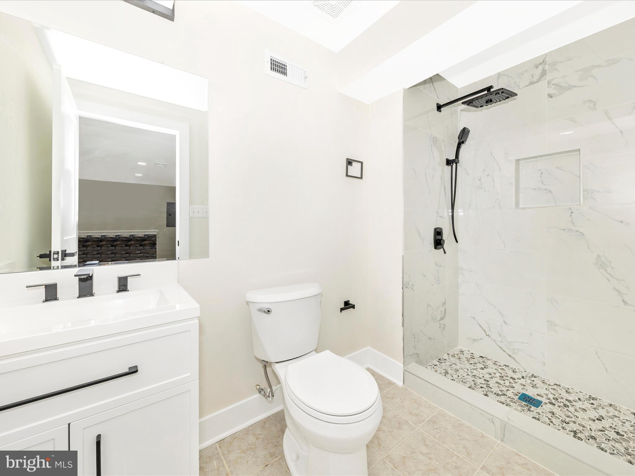 2621 Bear Den Road Frederick, MD 21701 - Photo 45 of 77 a bathroom with a sink toilet vanity and shower