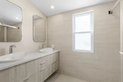 a bathroom with 2 sink and a mirror