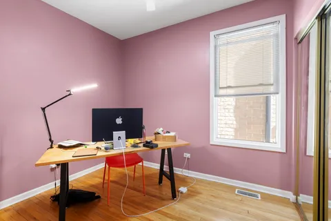 a view of a workspace with furniture and window