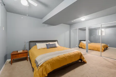 a bedroom with a bed and lamp