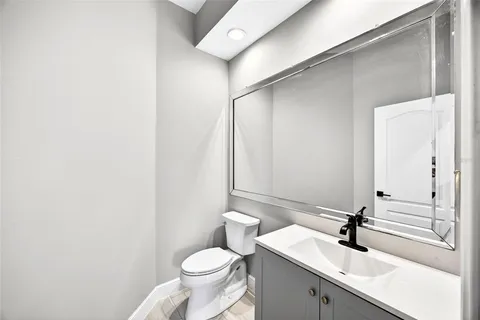 a bathroom with a sink a toilet and mirror