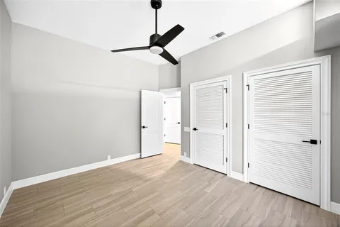 a view of empty room with wooden floor